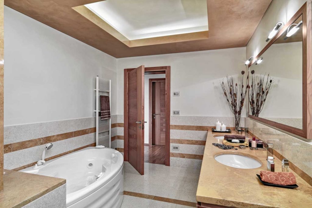 beautiful bathroom with white tub and double sinks